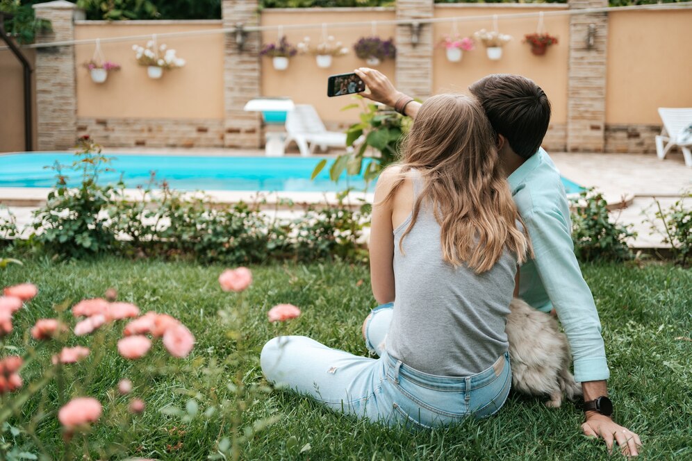 beautiful-happy-couple-making-selfie-with-their-lovely-dog-backyard-while-sitting-grass_158595-6557.jpg